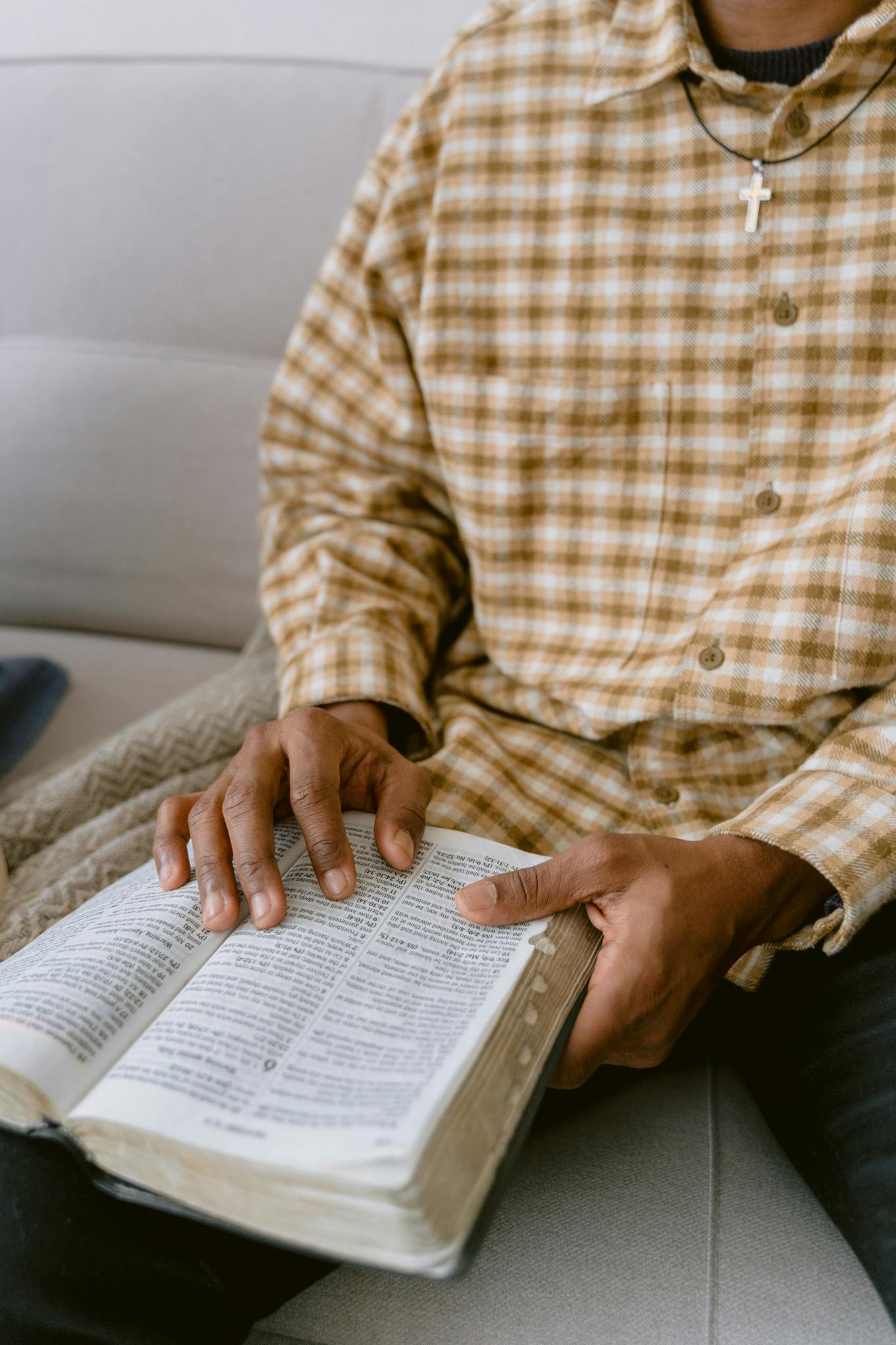 A close-up of a man reading a Bible, emphasizing faith and reflection.